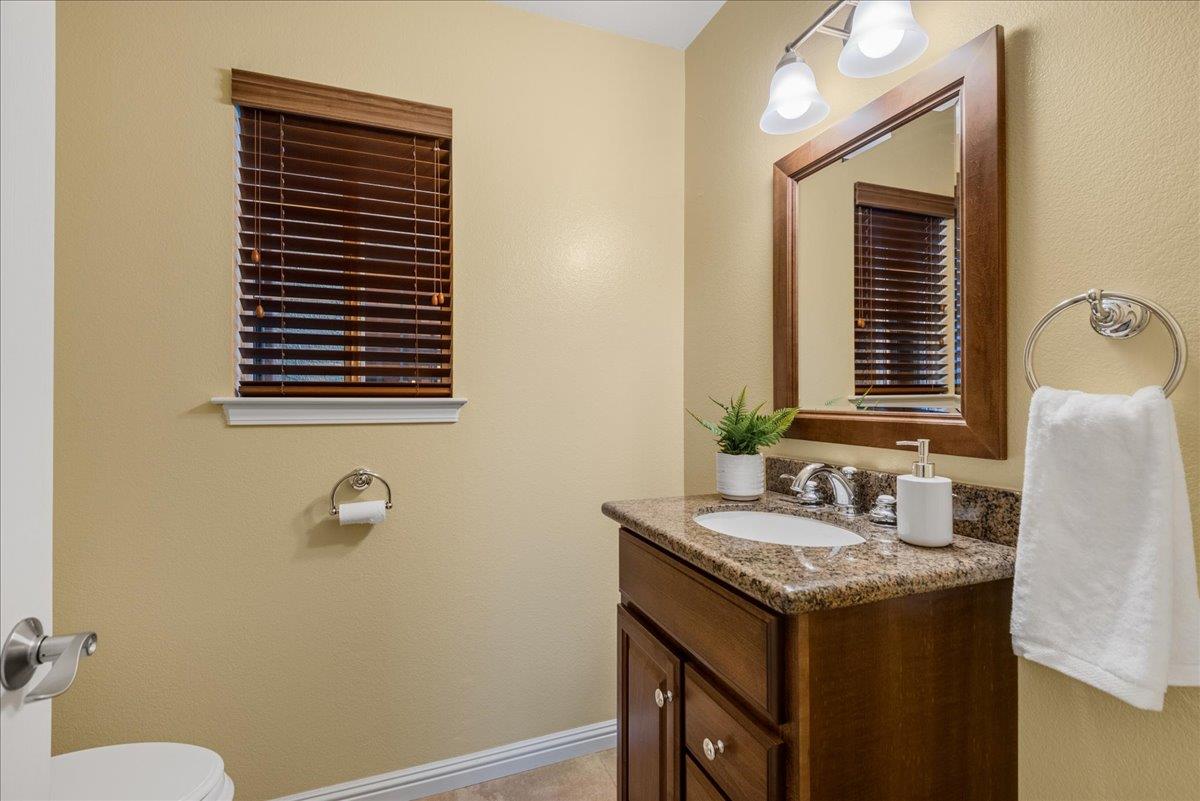 17446 Serene Drive Morgan Hill, CA 95037 - Photo 43 of 82 a bathroom with a granite countertop sink and a mirror