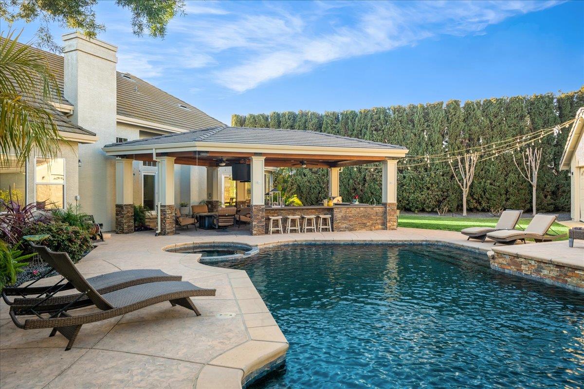 17446 Serene Drive Morgan Hill, CA 95037 - Photo 66 of 82 a view of a swimming pool and lounge chairs in patio