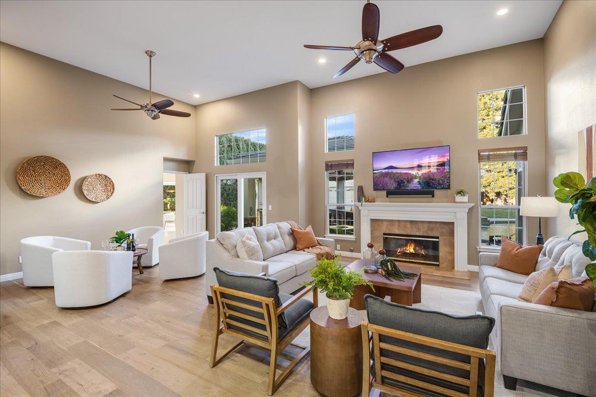 17446 Serene Drive Morgan Hill, CA 95037 - Photo 10 of 82 a living room with furniture a fireplace and a flat screen tv