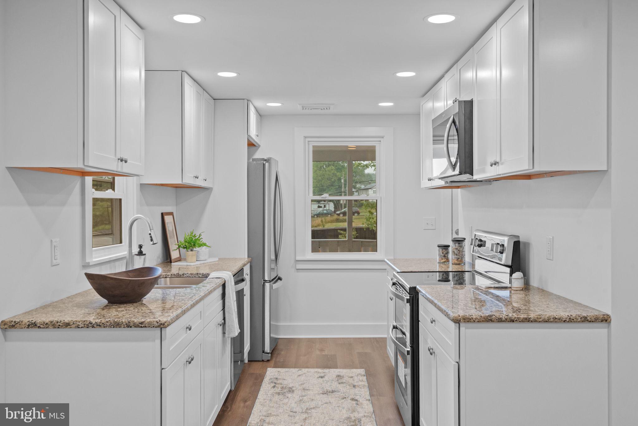229 Cider Press Road Manheim, PA 17545 - Photo 13 of 47 a kitchen with granite countertop a sink a stove and cabinets