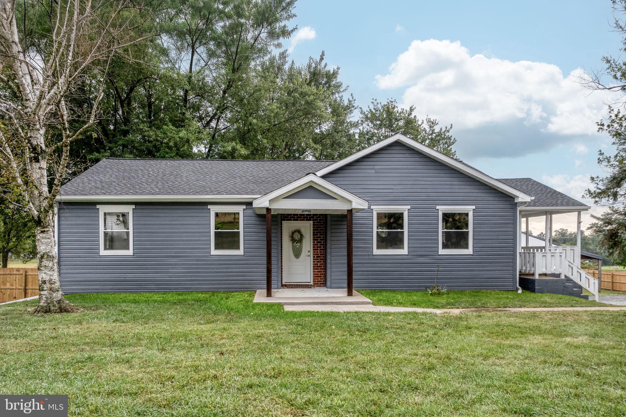 229 Cider Press Road Manheim, PA 17545 - Photo 2 of 47 a brick house with a small yard and wooden fence