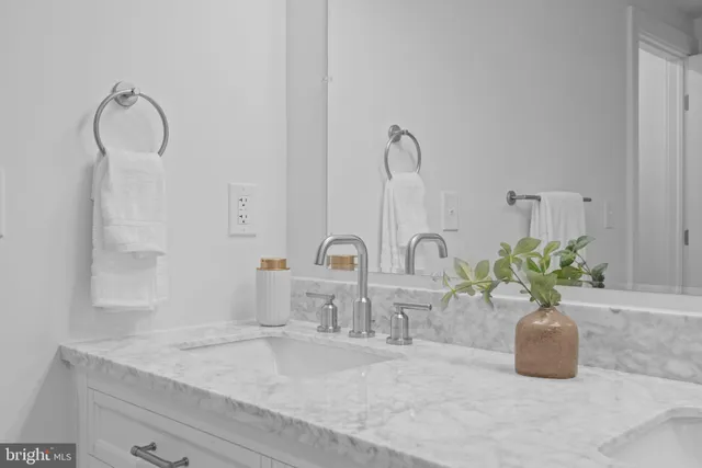 a bathroom with a double vanity sink and a mirror