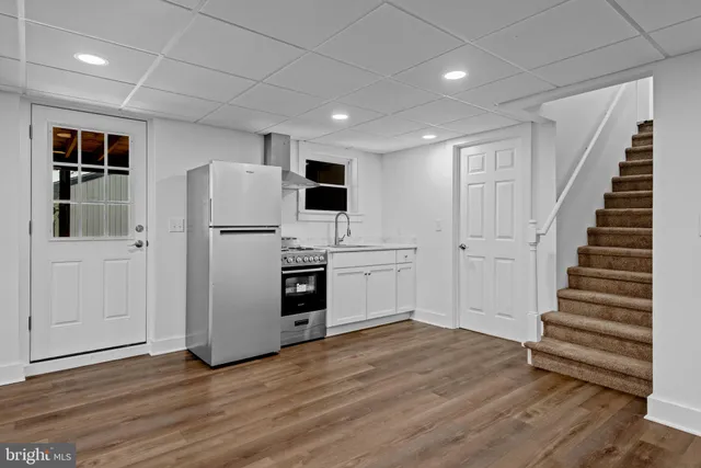 a view of kitchen with wooden floor and electronic appliances