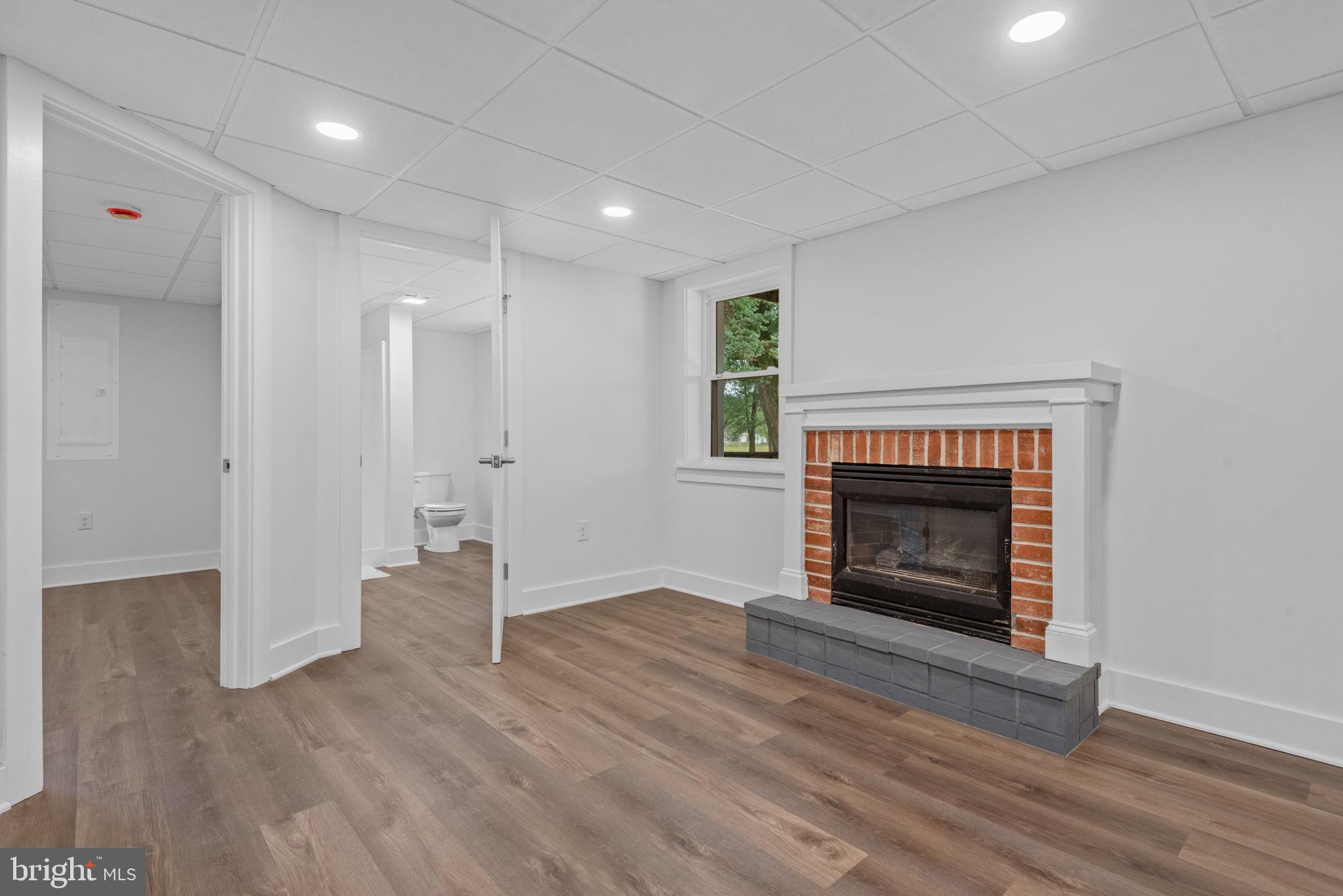 229 Cider Press Road Manheim, PA 17545 - Photo 33 of 47 a view of an empty room with wooden floor fireplace and a window