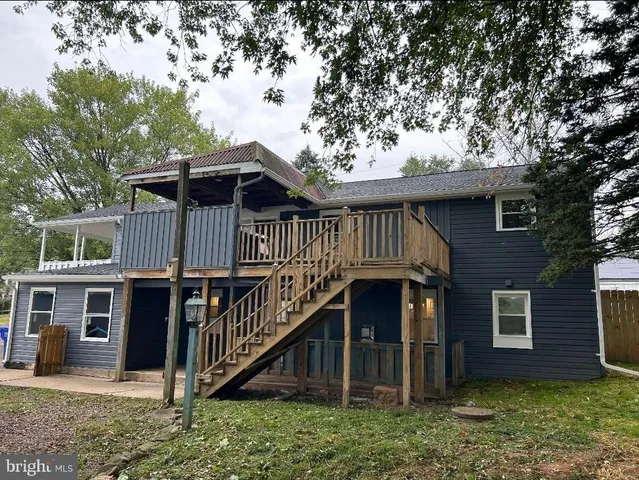 a view of a house with a yard and deck