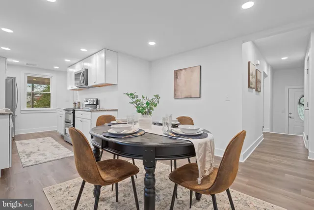 a view of a dining room with furniture and wooden floor