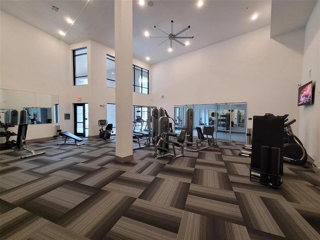 2700 Old Denton Road, Unit 2238 Carrollton, TX 75007 - Photo 8 of 21 Fitness center with high ceilings, patterned carpet tile flooring, and large windows