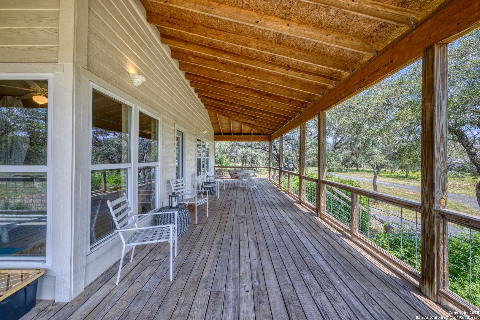 565 Loop Road Uvalde, TX 78801 - Photo 20 of 78 a view of balcony with chairs and wooden floor