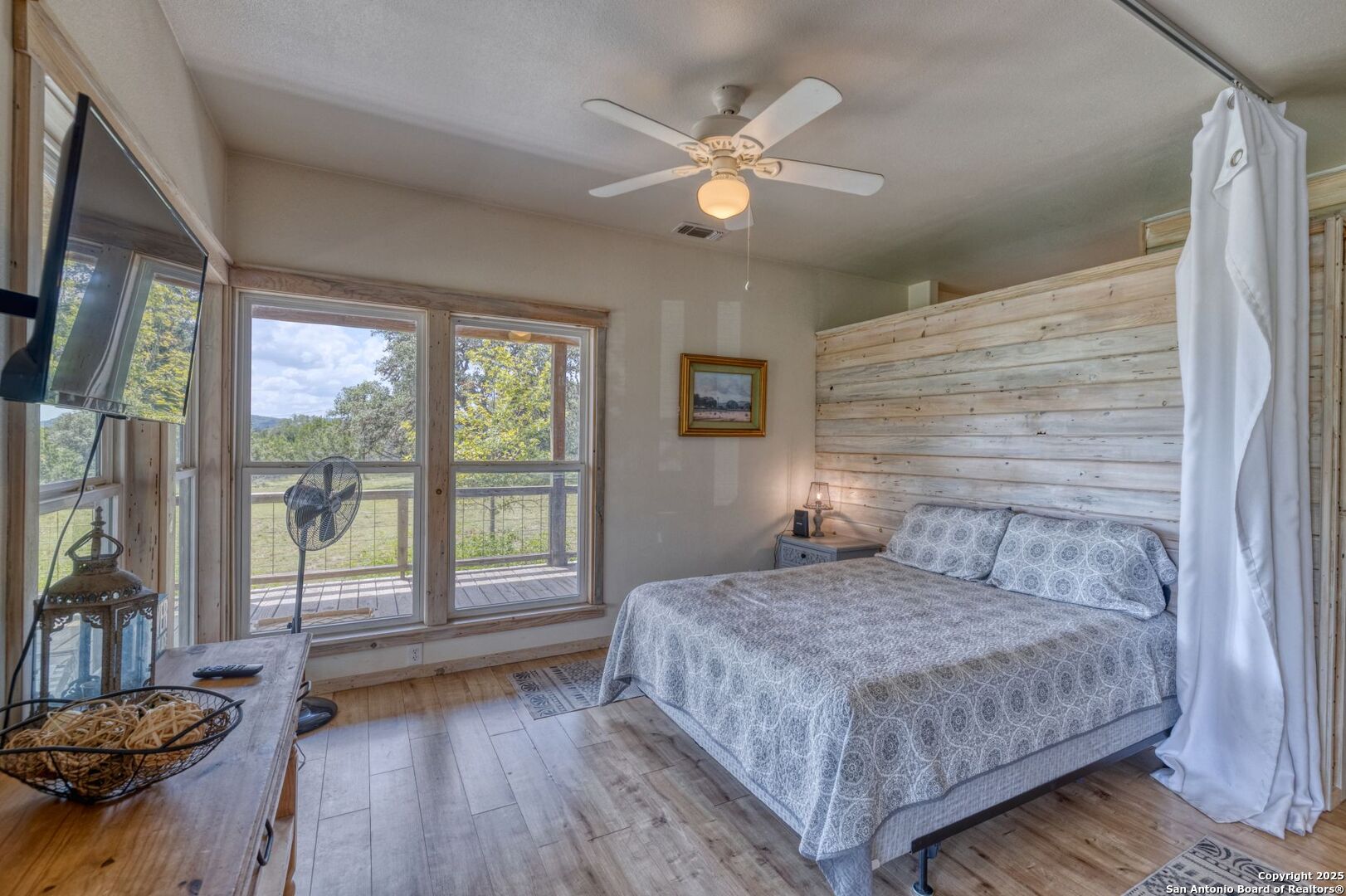 565 Loop Road Uvalde, TX 78801 - Photo 26 of 78 a bedroom with a large bed and a large window