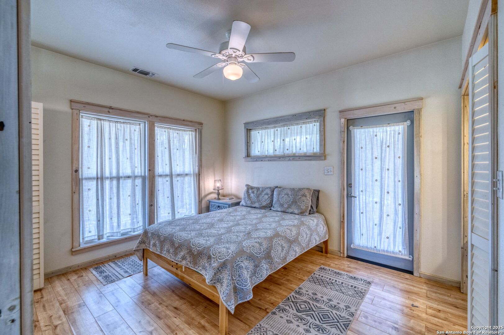 565 Loop Road Uvalde, TX 78801 - Photo 27 of 78 a bedroom with a large bed and a chandelier