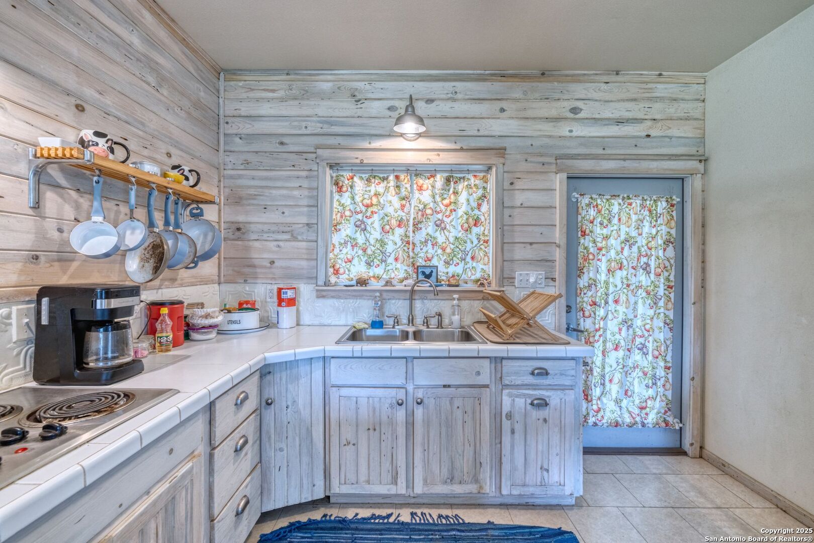 565 Loop Road Uvalde, TX 78801 - Photo 34 of 78 a kitchen with a stove and cabinets