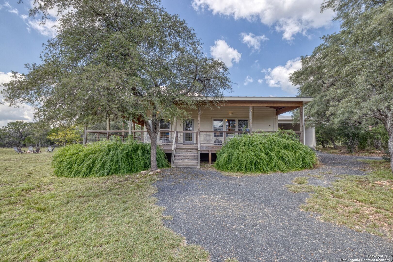 565 Loop Road Uvalde, TX 78801 - Photo 4 of 78 a view of a house with a big yard plants and large trees
