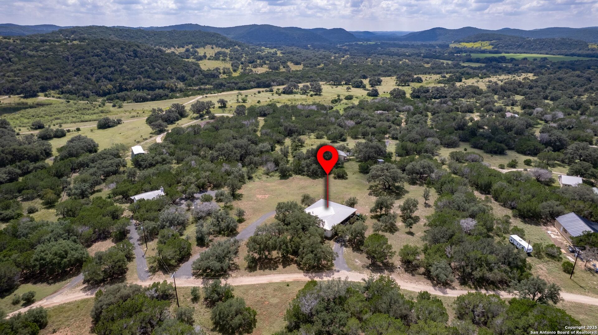 565 Loop Road Uvalde, TX 78801 - Photo 46 of 78 a view of a house with a mountain and a forest