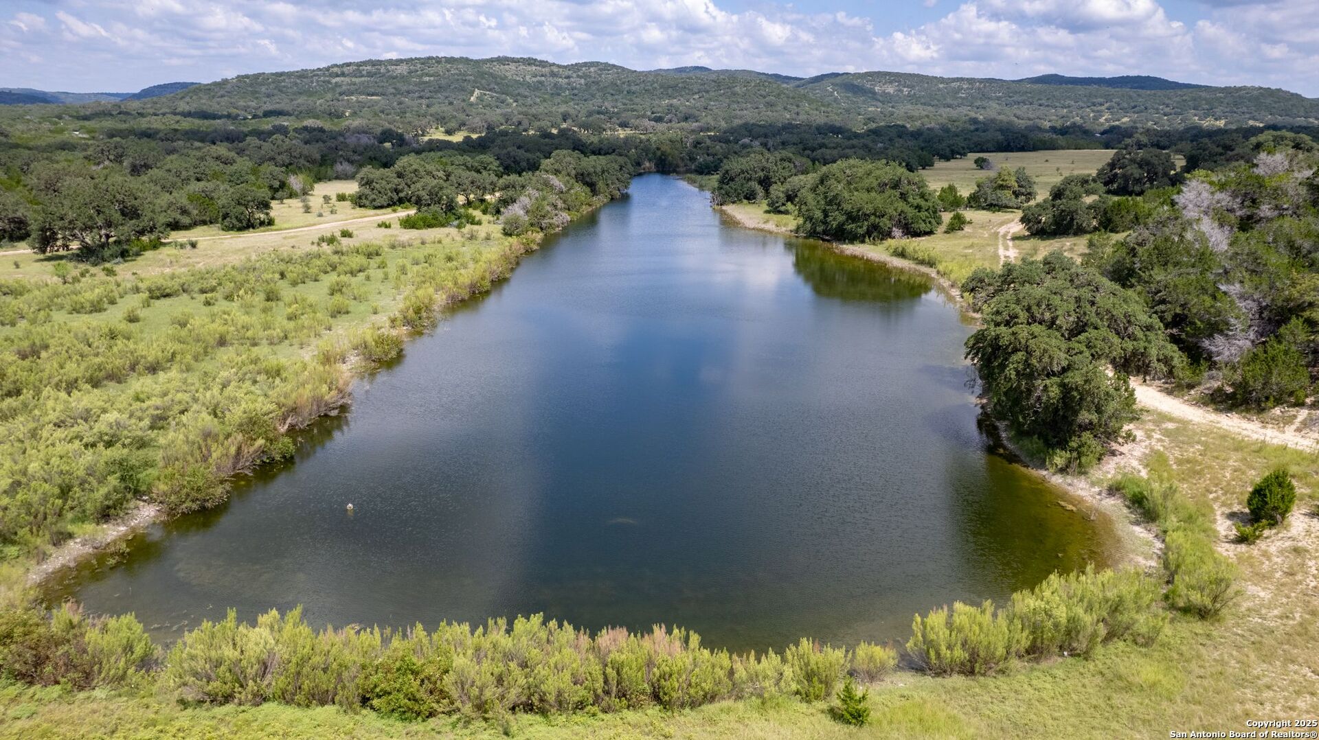 565 Loop Road Uvalde, TX 78801 - Photo 56 of 78 a view of a lake with a mountain in the background