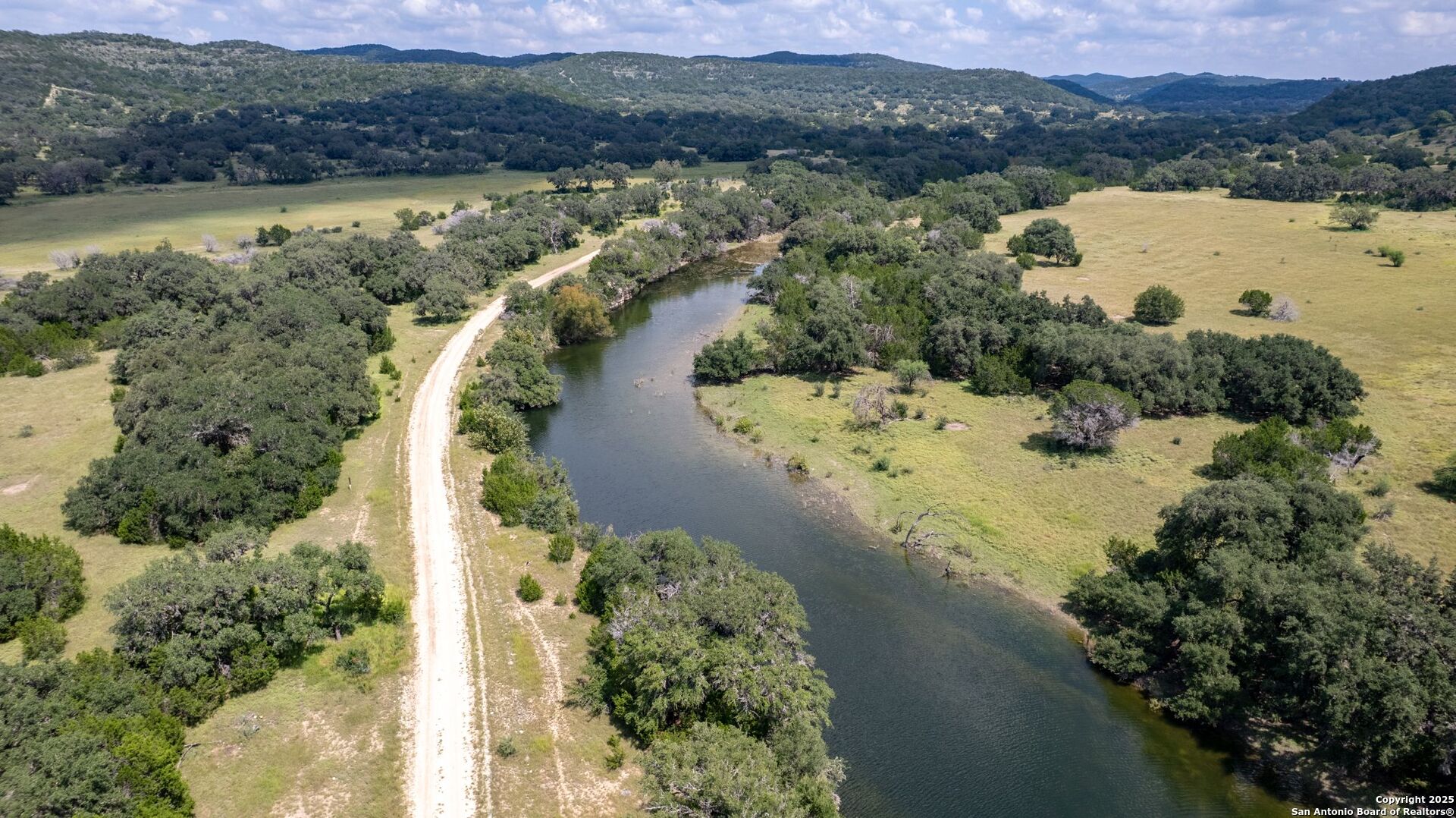 565 Loop Road Uvalde, TX 78801 - Photo 60 of 78 a view of a lake with a mountain in the background
