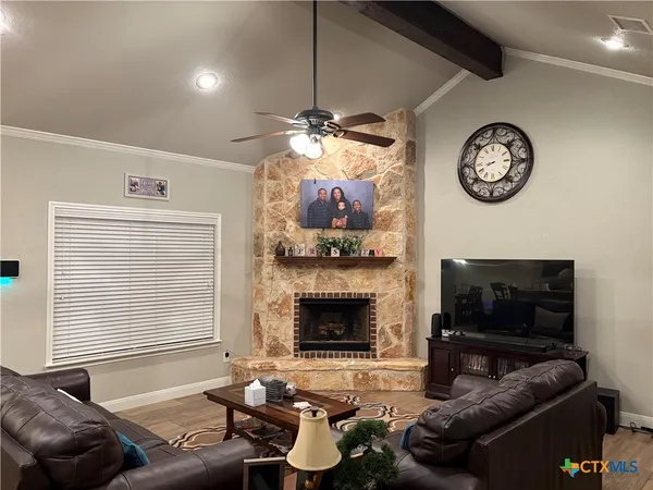 a living room with furniture a fireplace and a window