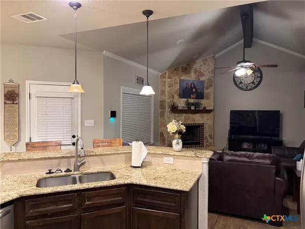 a kitchen with sink and cabinets