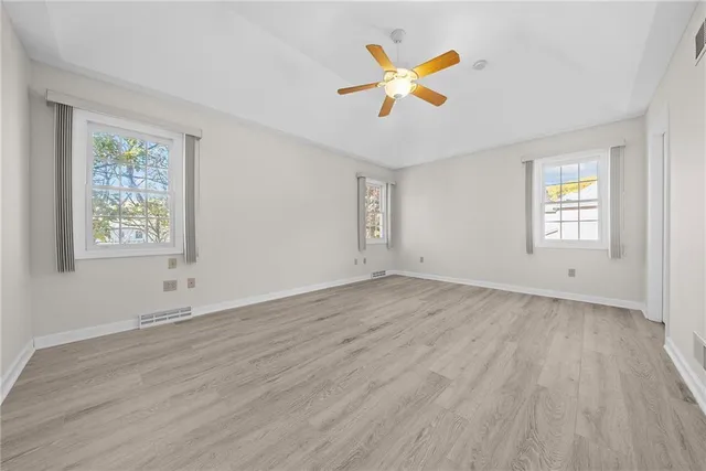 a view of a room with wooden floor and window