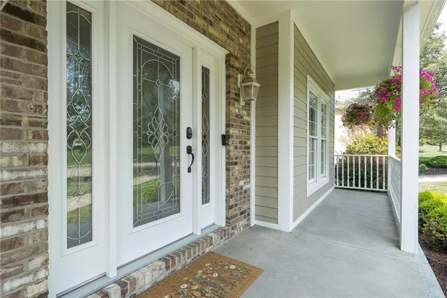 a view of a porch with a table and chairs