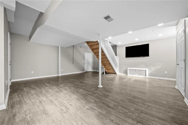 a view of a livingroom with wooden floor and an empty space