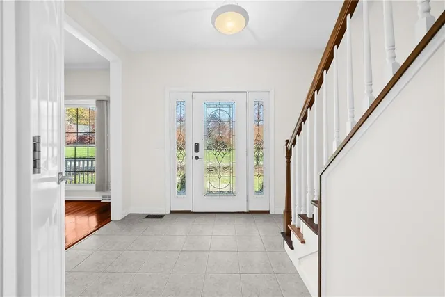 a view of an entryway with wooden floor and windows