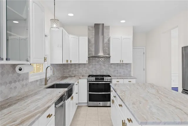 a kitchen with granite countertop a sink a stove and refrigerator