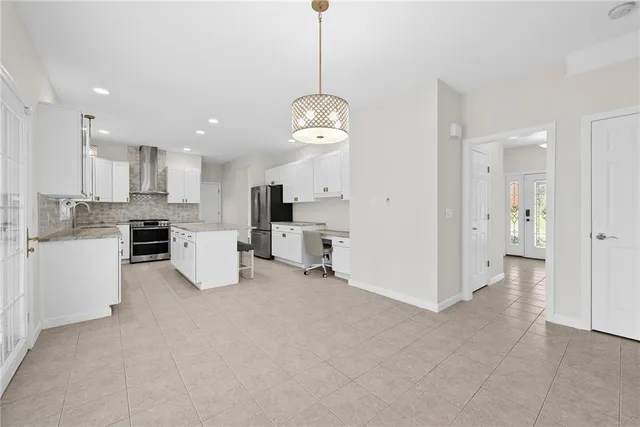 a view of a kitchen with center island and stainless steel appliances
