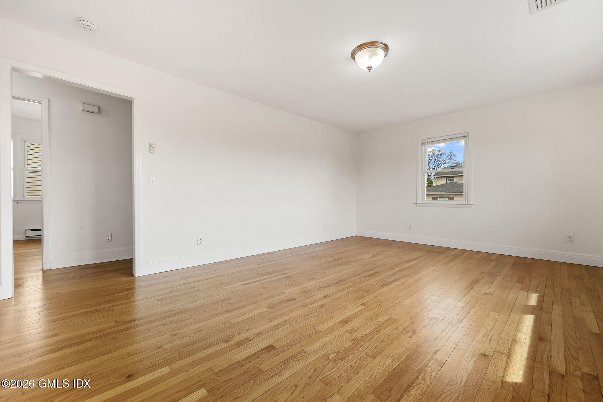 2 Grange Street Greenwich, CT 06830 - Photo 17 of 31 an empty room with wooden floor and windows