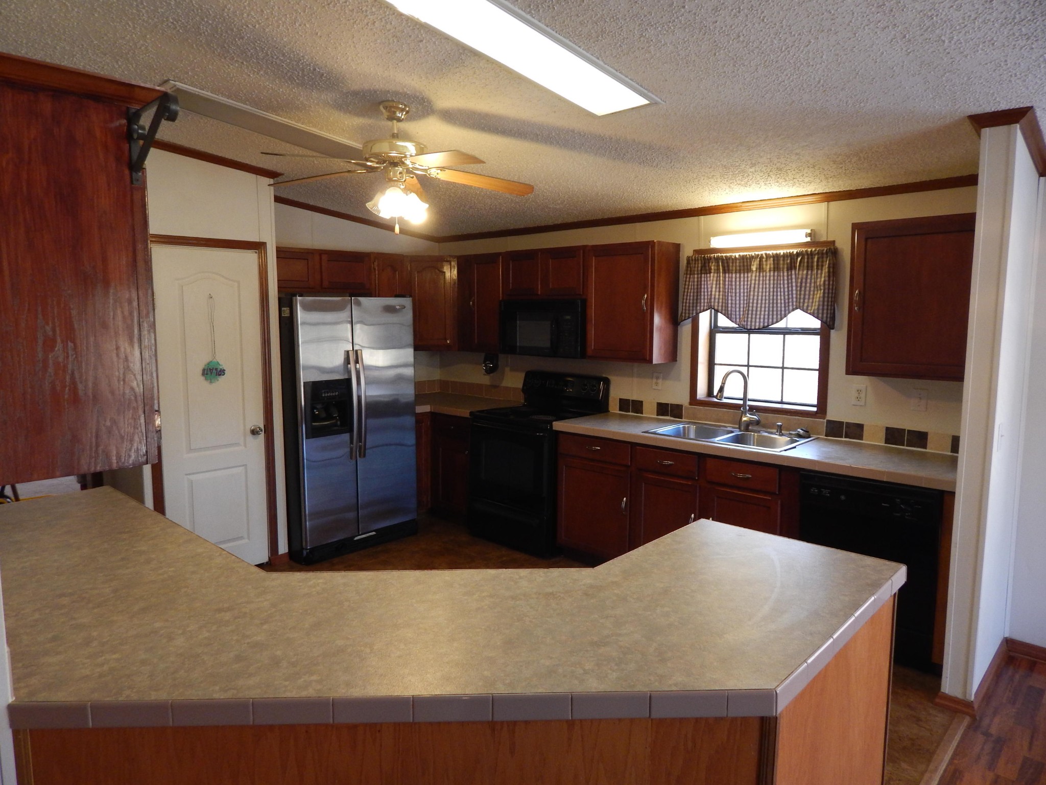 193 Crisman Road Heiskell, TN 37754 - Photo 24 of 31 a kitchen with stainless steel appliances granite countertop a refrigerator a sink a stove and island