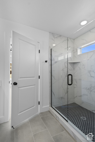 249 West 2920th Street South Logan, UT 84321 - Photo 14 of 23 Walk-in shower with clear glass enclosure and black hexagon tile floor