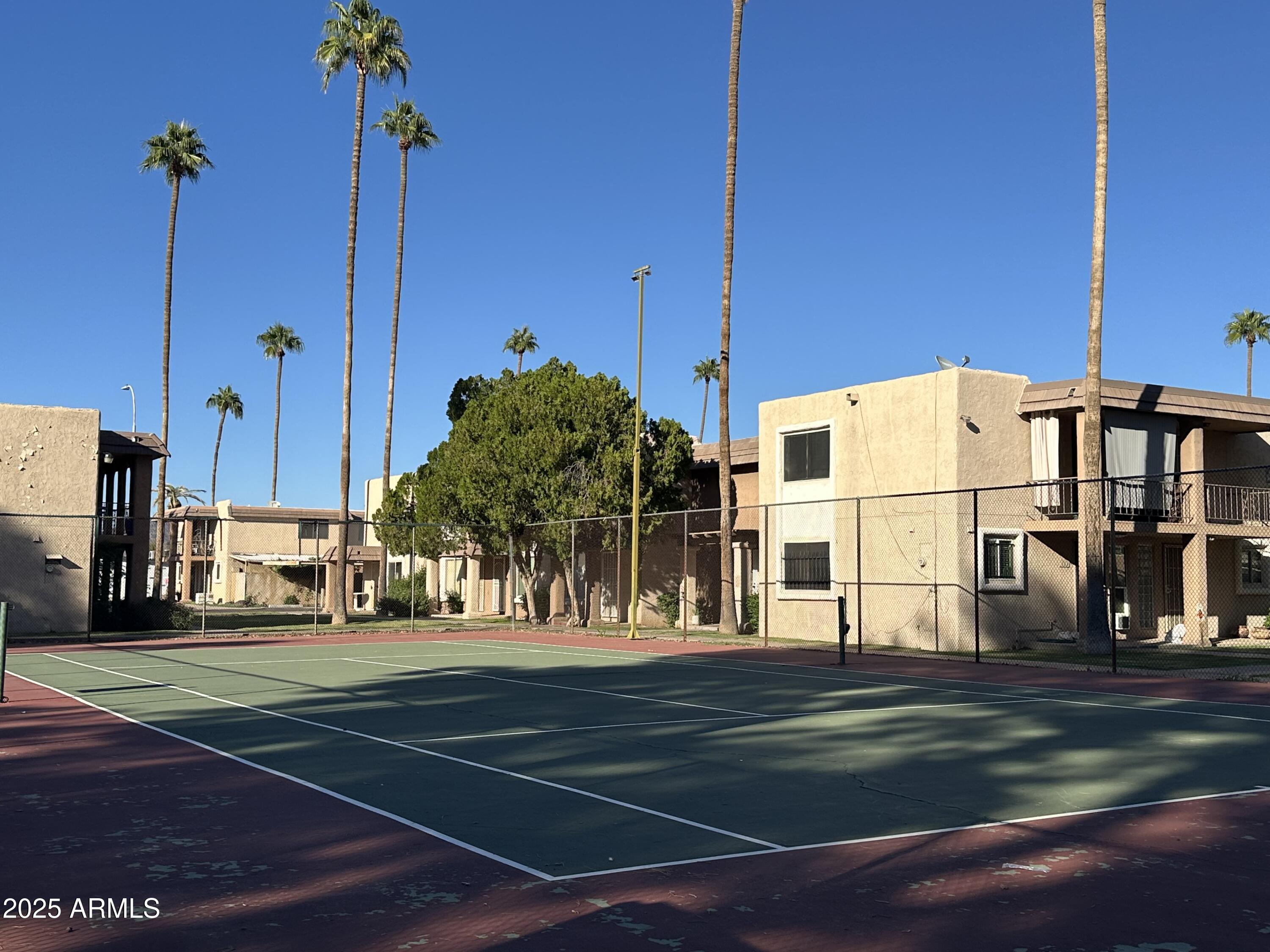 7126 North 19th Avenue, Unit 140 Phoenix, AZ 85021 - Photo 16 of 17 a view of a tall building next to a yard