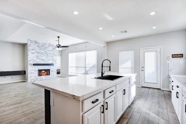 a kitchen with sink cabinets and wooden floor