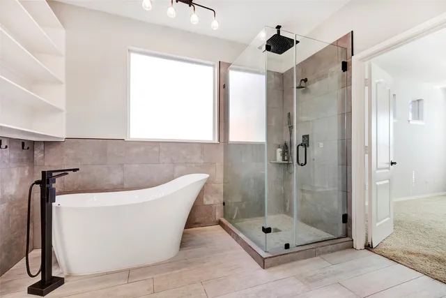 a bathroom with a bathtub and shower