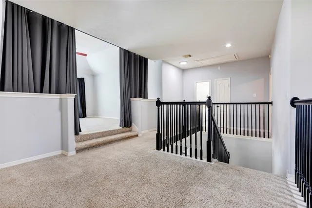a view of a hallway with a livingroom and entryway