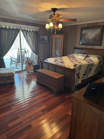 a bedroom with double bed and a chandelier