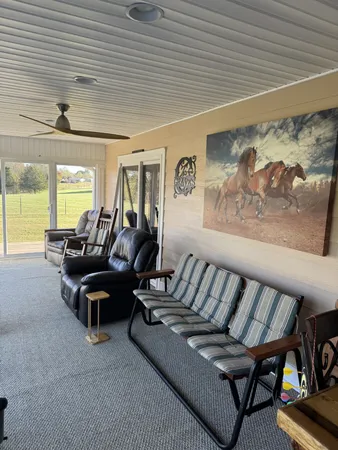 a room with pool table and windows