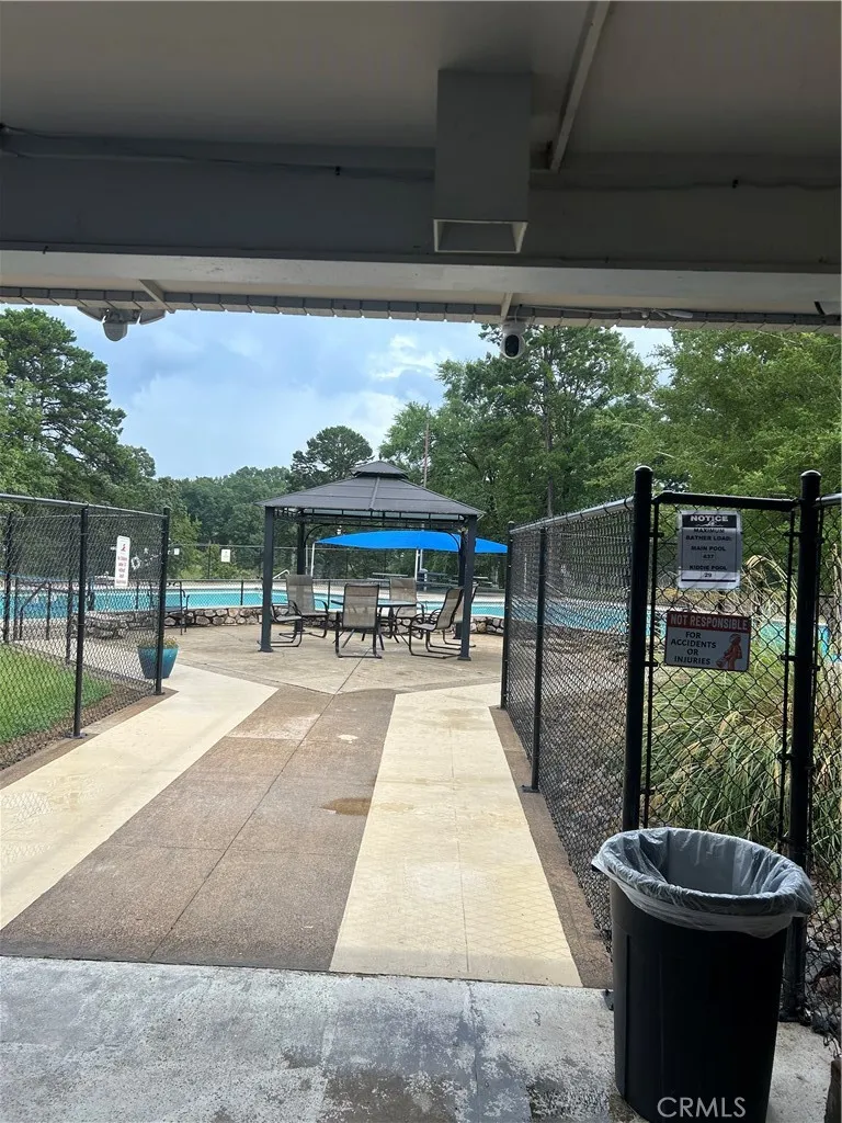 24 Edgemont Outside Area (outside Ca), AR 71913 - Photo 9 of 12 a view of a patio with a table and chairs under an umbrella with a tub