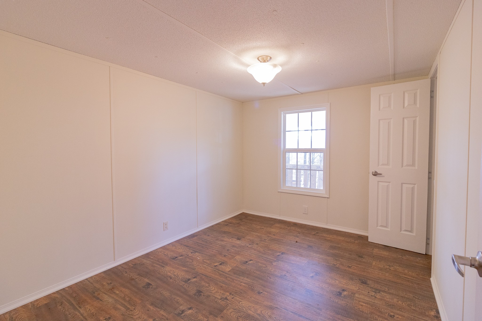 833 Speck Road Lebanon, TN 37087 - Photo 13 of 40 an empty room with wooden floor and windows