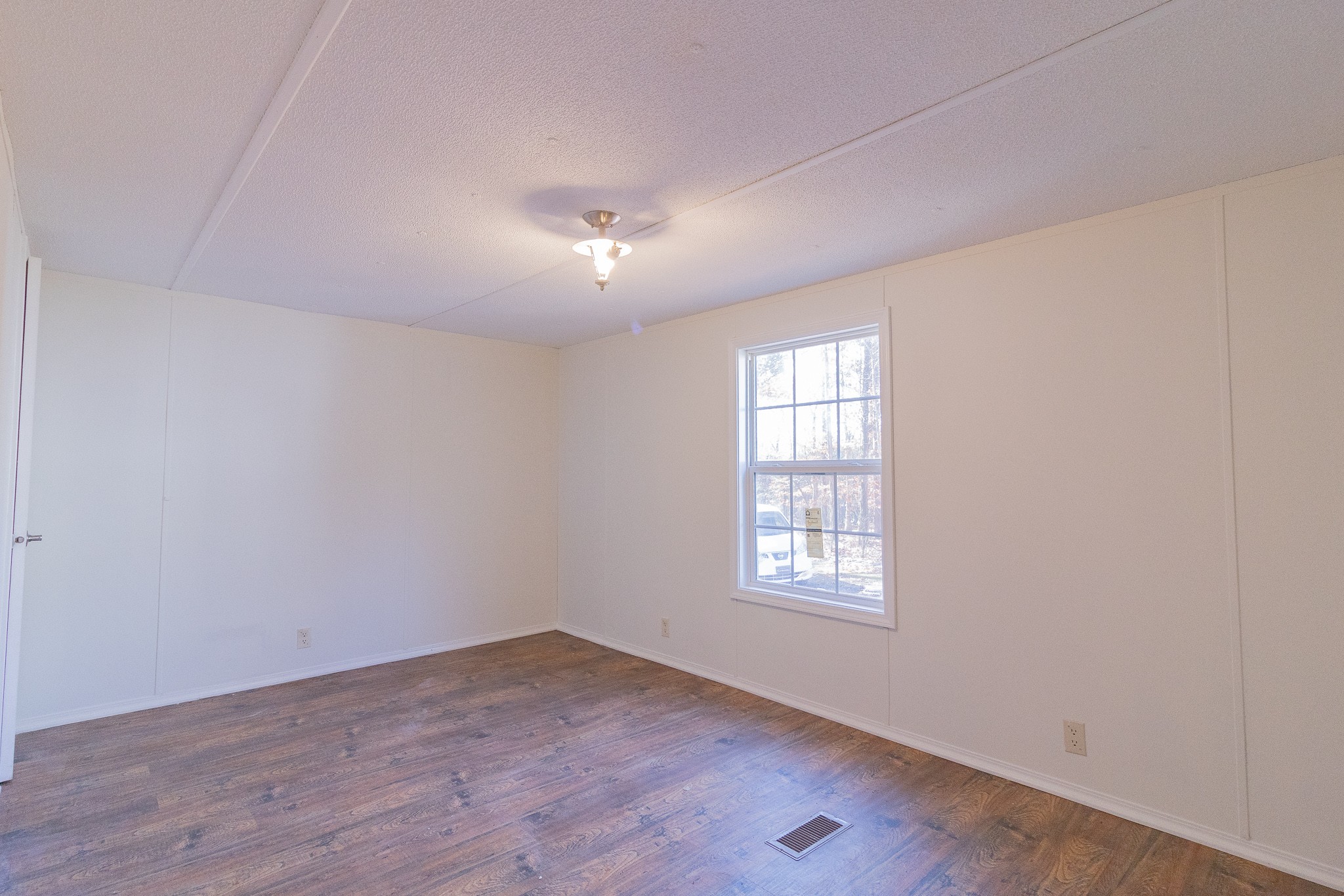 833 Speck Road Lebanon, TN 37087 - Photo 15 of 40 an empty room with wooden floor and windows