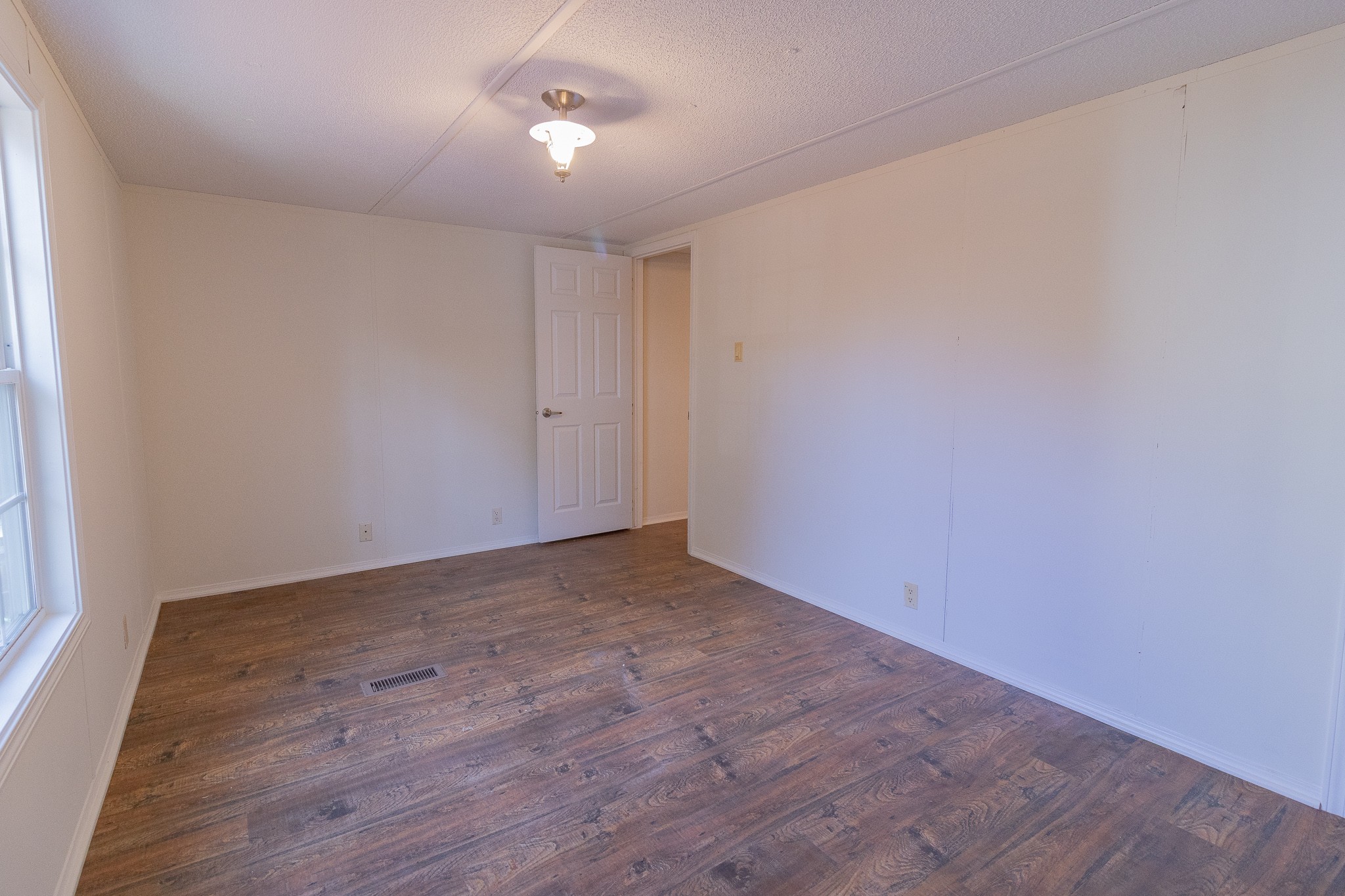 833 Speck Road Lebanon, TN 37087 - Photo 17 of 40 a view of an empty room with wooden floor