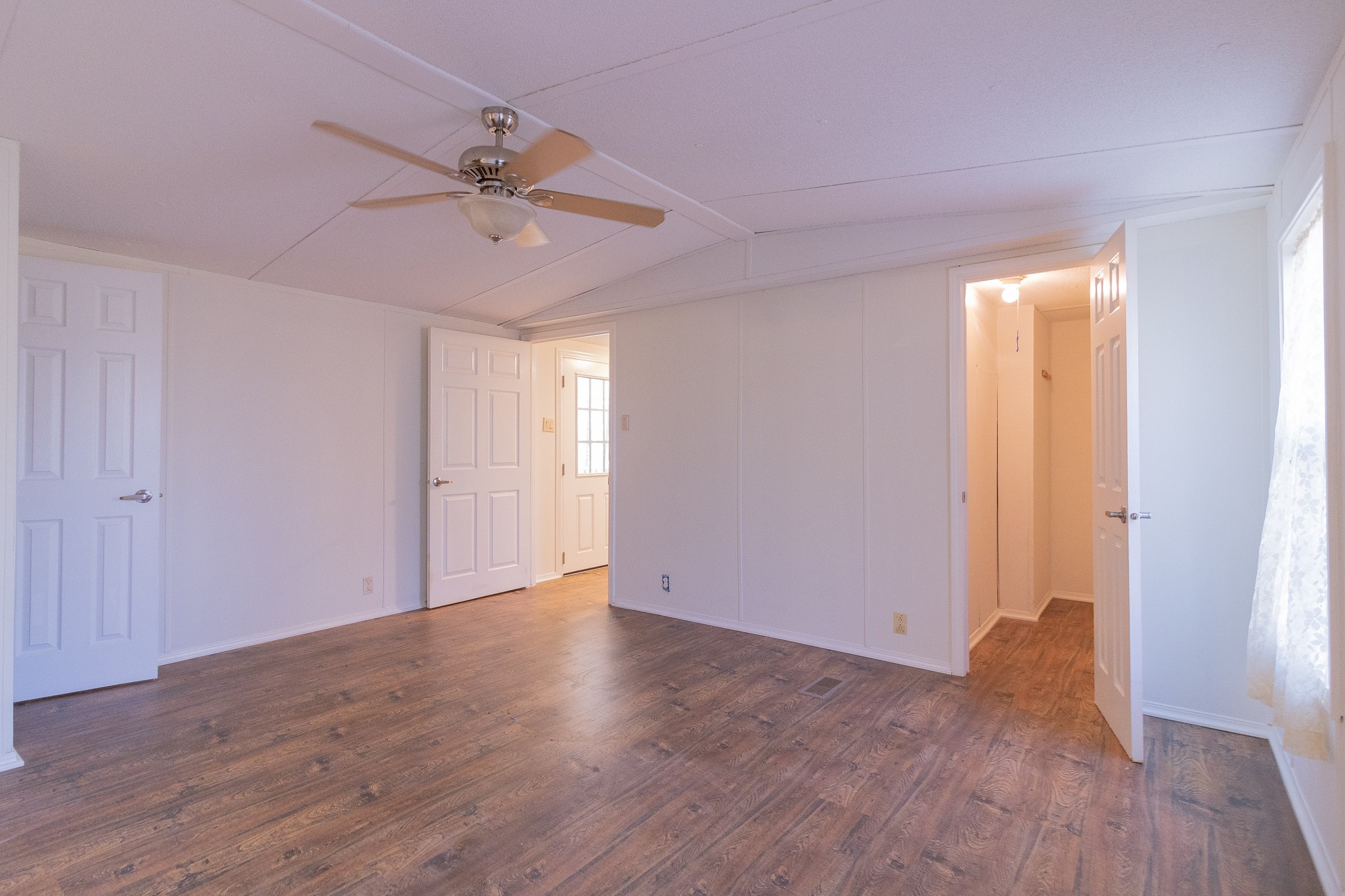 833 Speck Road Lebanon, TN 37087 - Photo 19 of 40 an empty room with wooden floor fan and windows
