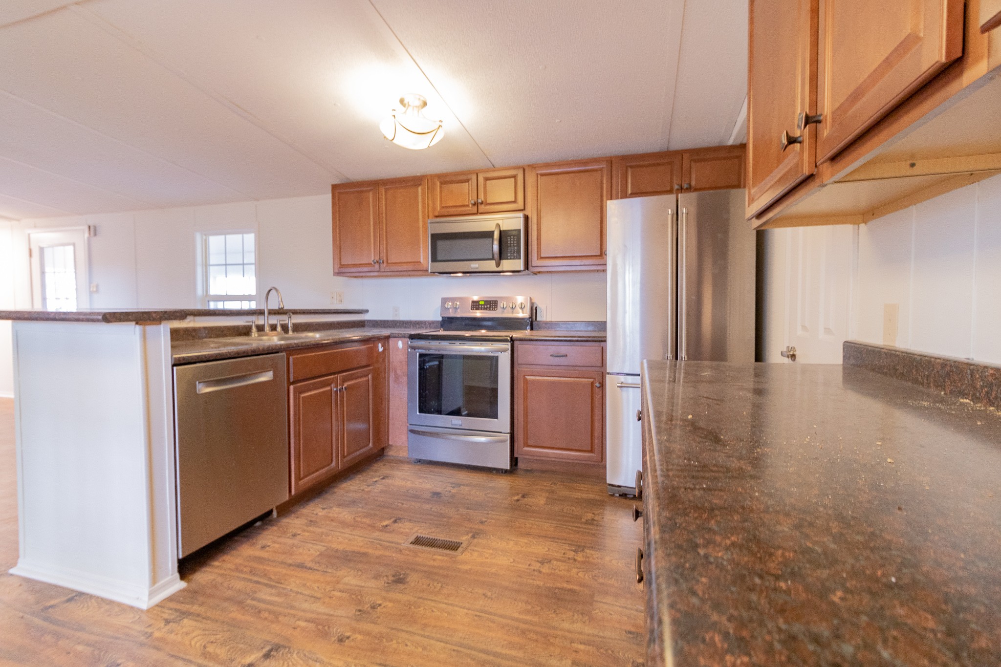 833 Speck Road Lebanon, TN 37087 - Photo 10 of 40 a kitchen with stainless steel appliances granite countertop a stove a sink dishwasher and a refrigerator