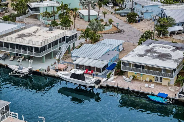 an aerial view of a house with swimming pool and sitting area
