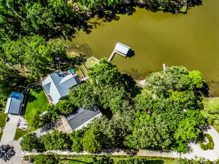 an aerial view of a house with lake view