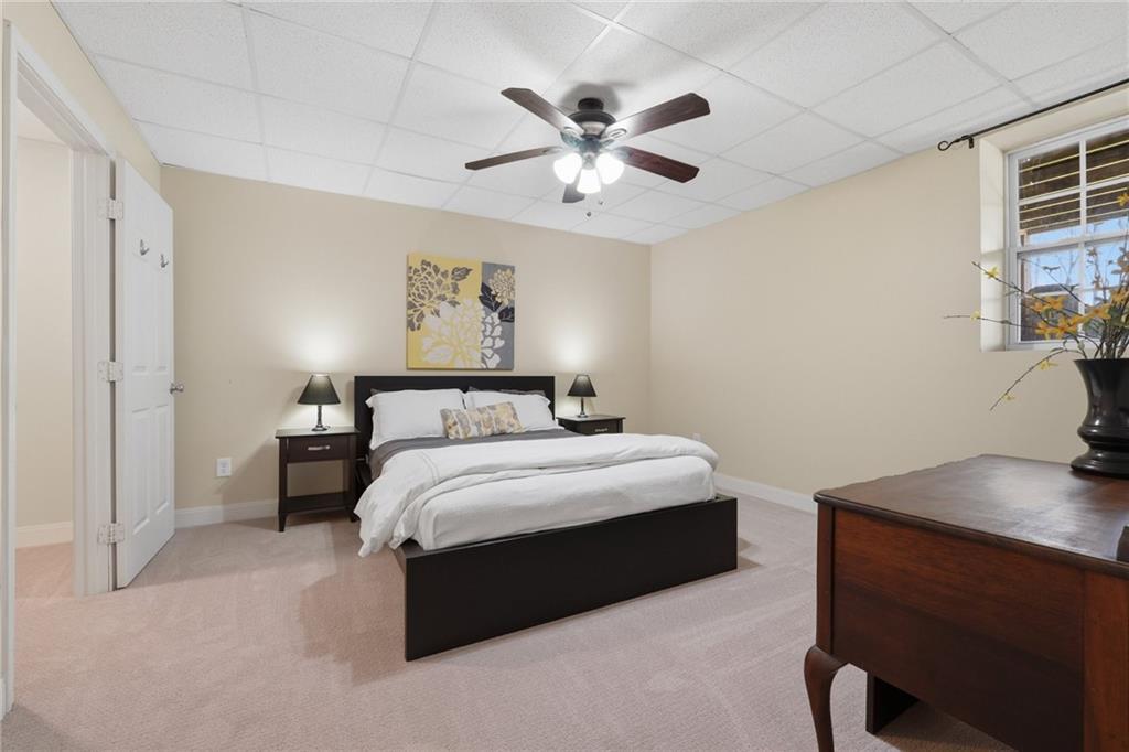 3341 Danielle Way Suwanee, GA 30024 - Photo 29 of 39 a bedroom with a bed and a chandelier