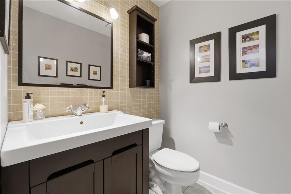 3341 Danielle Way Suwanee, GA 30024 - Photo 34 of 39 a bathroom with a toilet sink and mirror