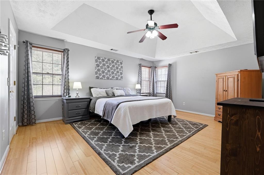 3341 Danielle Way Suwanee, GA 30024 - Photo 5 of 39 a bedroom with a bed and wooden floor