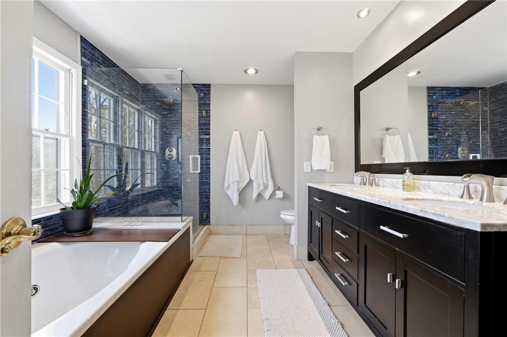 3341 Danielle Way Suwanee, GA 30024 - Photo 7 of 39 a spacious bathroom with a double vanity sink and a bathtub