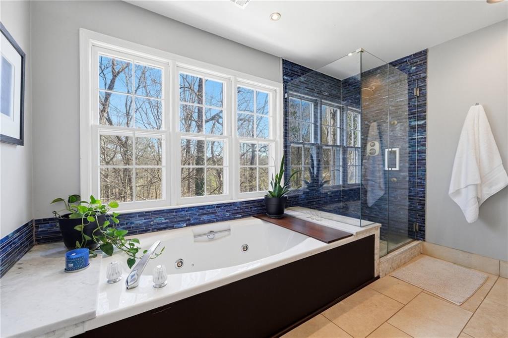 3341 Danielle Way Suwanee, GA 30024 - Photo 8 of 39 a bath tub sitting in a bathroom next to a window