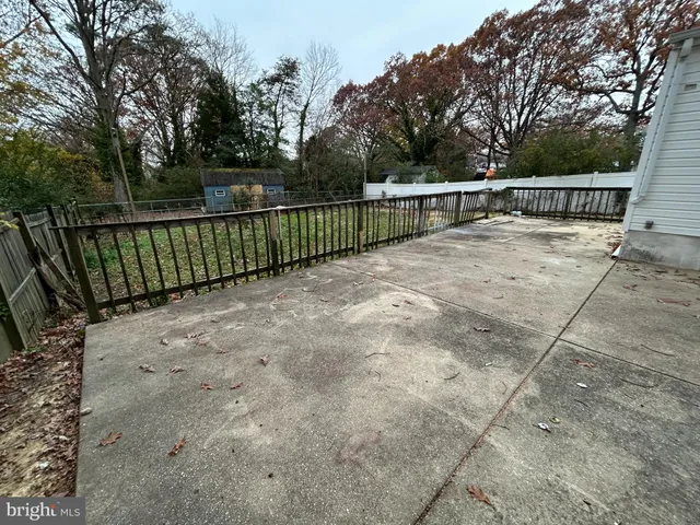 a view of street with wooden fence
